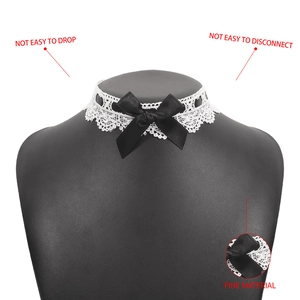 Close-up of white lace choker necklace featuring a black satin bow and durable fine material