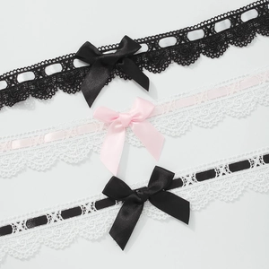 Detail view of lace bow chokers in black and white with satin ribbons for women