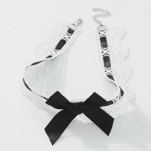 Elegant white lace choker necklace with a large black bow and adjustable silver chain