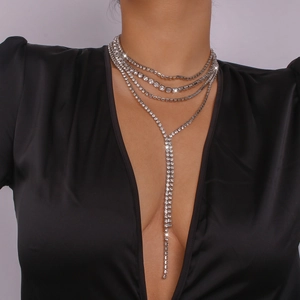Macro shot of multilayered rhinestone choker necklace with elegant long tassel pendant