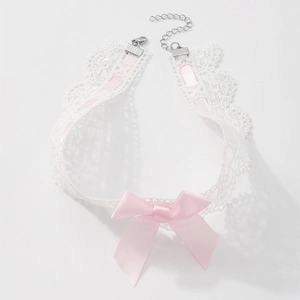 Macro shot of white lace choker featuring pink satin ribbon and adjustable lobster clasp