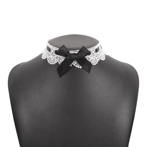 Detailed view of white lace choker necklace featuring a black satin bow on mannequin
