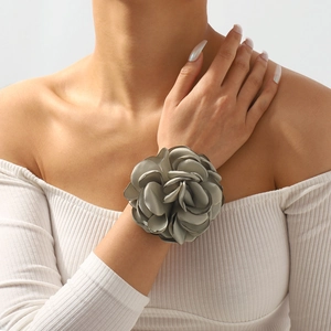 Detailed view of grey silk rose bracelet with layered satin petals on a wrist