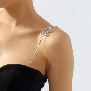 Detail view of shimmering rhinestone shoulder strap with elegant floral silver accents