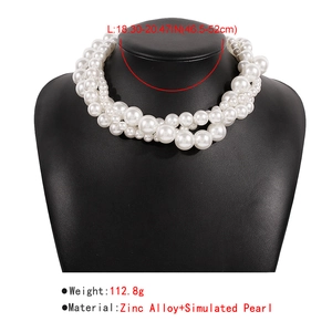 Macro view of multi-layer faux pearl choker necklace on black jewelry display stand