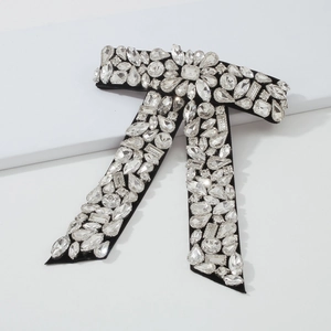 Barrette nœud géante en velours noir ornée de cristaux de strass étincelants de luxe