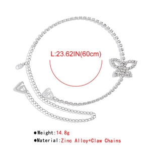 Detail showing shiny silver butterfly body chain with rhinestones and claw chain design