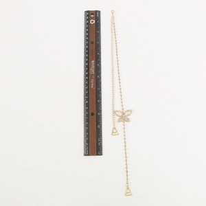 Detail of gold butterfly body chain with sparkling rhinestones and metal hooks