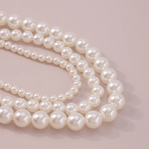 Detail of multi-layered pearl choker necklace with various pearl sizes and smooth luster