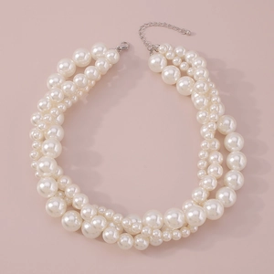 Close-up of elegant multi-layered white pearl choker with adjustable silver metal clasp