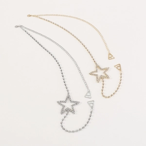 Detailed view of gold and silver star body chains with shimmering rhinestone accents