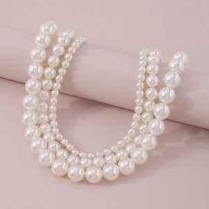 Detailed view of layered white pearl choker necklace with three rows of elegant beads