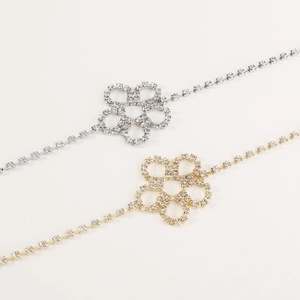 Close-up of gold and silver flower body chains with shimmering crystal rhinestones
