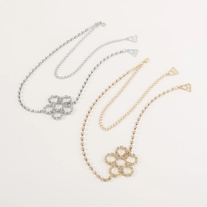 Detailed view of rhinestone butterfly bra straps in silver and gold metal finishes