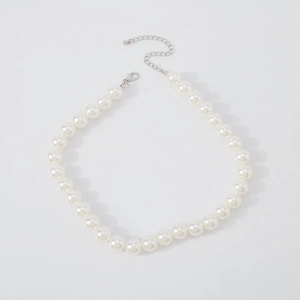Detailed shot of white pearls with adjustable silver metal chain and lobster clasp closure