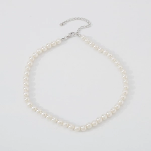 Detail of elegant white pearl choker necklace with adjustable silver lobster clasp closure