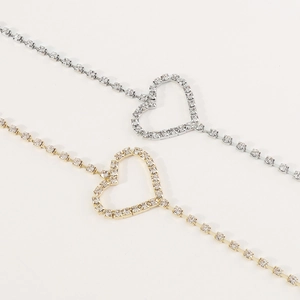 Close-up of sparkling rhinestone heart-shaped body chain in gold and silver finish