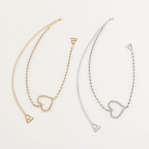 Detailed view of silver and gold heart rhinestone straps with adjustable metal hooks