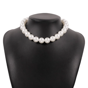 Elegant chunky white pearl choker necklace displayed on a black classic jewelry bust