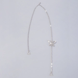 Close-up of a silver butterfly body chain featuring sparkling rhinestones and long tassels