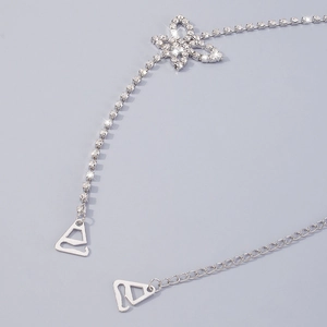 Detail of rhinestone body chain with floral center piece and adjustable silver extension link