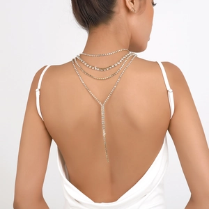 Macro detail of multilayer rhinestone back chain necklace with sparkling fringe tassel