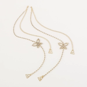 Detail of gold butterfly bra straps with sparkling rhinestones and metal hooks