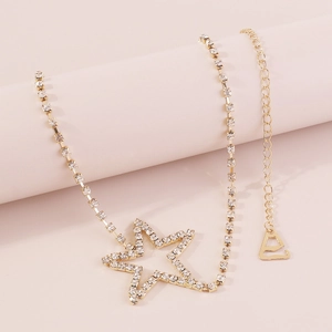 Close-up of golden choker with hollow star pendants and shimmering rhinestones