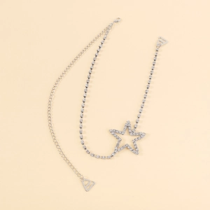 Detail of silver rhinestone shoulder strap featuring a hollow star and dual chain design