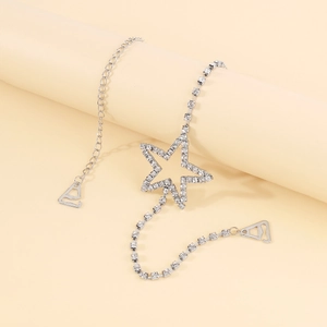 Detail of elegant star body chain with sparkling rhinestones and metal hooks accessory