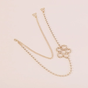 Detail of golden rhinestone butterfly body chain showing hollow flower pendant and hooks