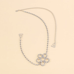 Detail of silver body chain with sparkling rhinestones and flower motif for shoulders