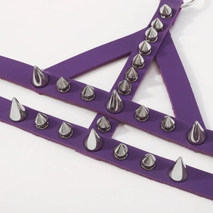 Detail of purple leather punk bracelet with silver metal spikes and ring connector