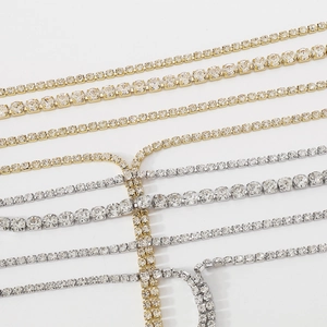 Detailed view of silver and gold tennis chains featuring sparkling round zircon stones