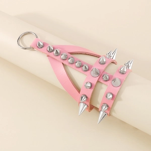 Detail of pink leather punk bracelet featuring silver metal cone spikes and metal ring