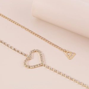 Close-up of heart-shaped rhinestone body chain with elegant gold-plated finish