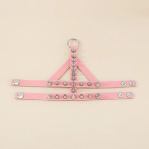 Close-up of pink punk leather harness with silver cone studs and metal ring detail