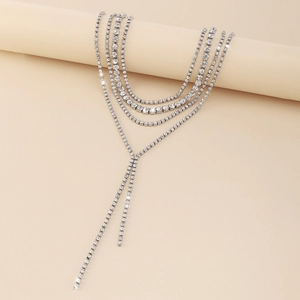Macro detail of multi-layer rhinestone fringe necklace showing silver tassel chain texture
