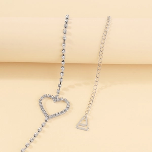 Detail of silver body chain with heart rhinestone decoration and adjustable lobster clasp