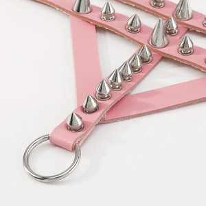 Detail of pink gothic PU leather strap with silver metal spikes and a bold O-ring