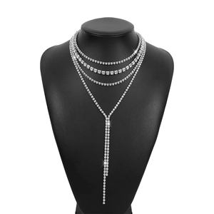 Macro detail of multilayer rhinestone necklace with long tassel back drop accessories