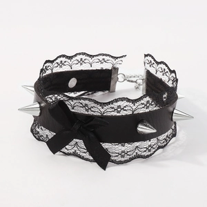 Detail of punk lace choker featuring silver metal spikes and a black ribbon bow tie