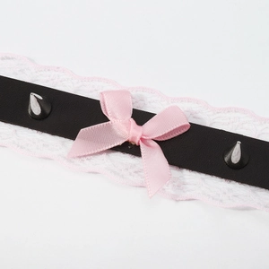 Close-up of black PU leather choker with pink lace trim, satin bow and metal studs