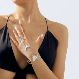 Detail of silver gothic butterfly slave bracelet with intricate filigree ring and hand chain