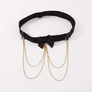 Detail of black elastic garter leg ring with ribbon bow and gold tassel chains