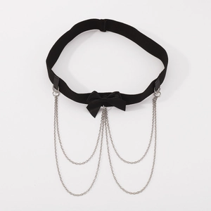 Detailed view of gothic black leather leg garter with satin bow and silver metal chains