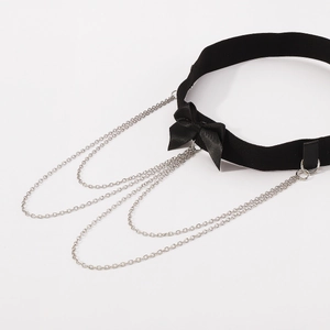 Detail of velvet choker featuring a bow and triple-layered silver tassel chains