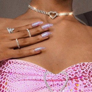 Close-up of double-row rhinestone heart pendant necklace and matching diamond ring set