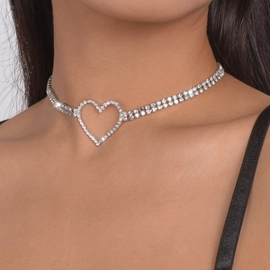 Close-up of a silver heart choker featuring double-row crystal claw chains on a model