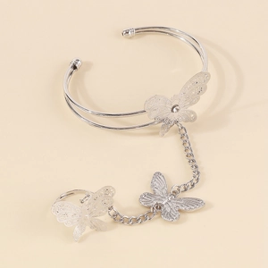 Macro shot of silver butterfly hand chain with hollow design and shiny rhinestones